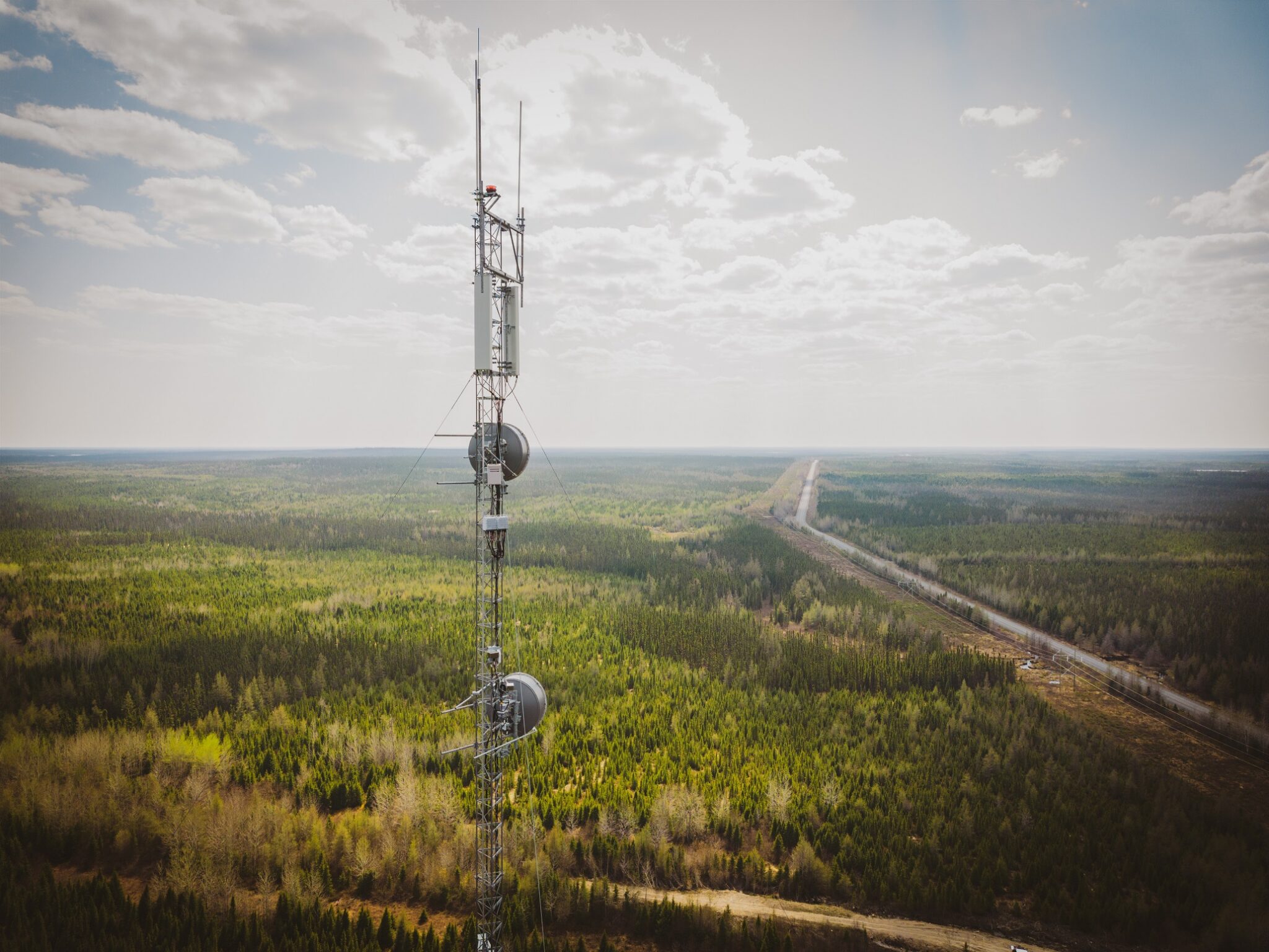 Rogers wireless tower infrastructure over a forested highway corridor